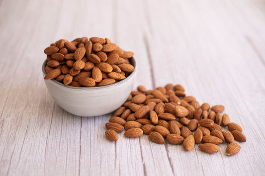 Organic Nonpareil almonds from True California, close-up of 1 lb bag showing the light, smooth almond kernels.
