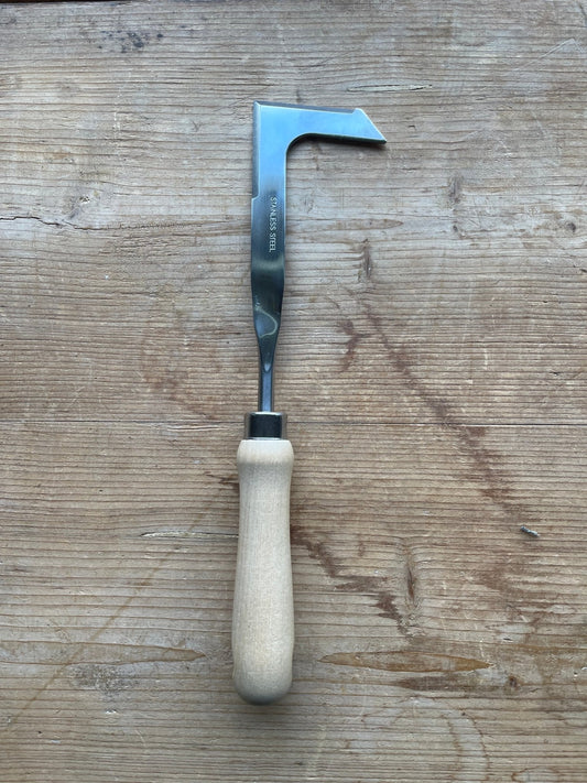 The Celtic Farm’s Unique Garden Tool Set & Gift features a light wooden handle and a shiny, angled L-shaped blade—combining function and style in a quality-crafted design, perfect for any gardening enthusiast.