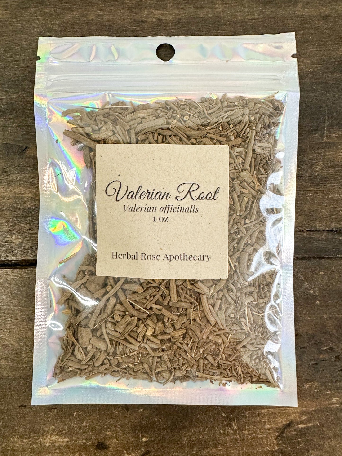 Dried valerian root herb in a 1oz package from HerbalRoseApothecary, showing earthy, twisted roots in natural light.