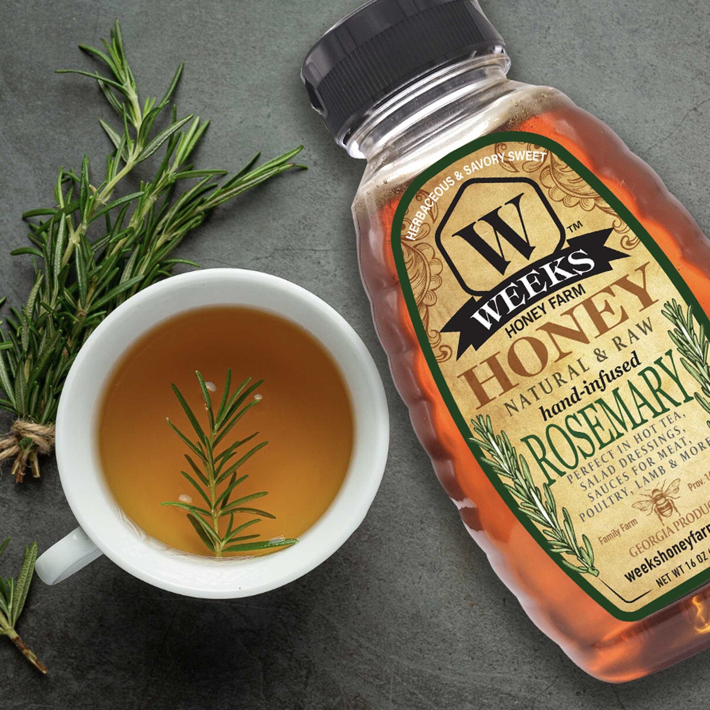 Hand-infused rosemary honey from Weeks Honey Farm, showcasing golden honey with rosemary herbs for teas and recipes.