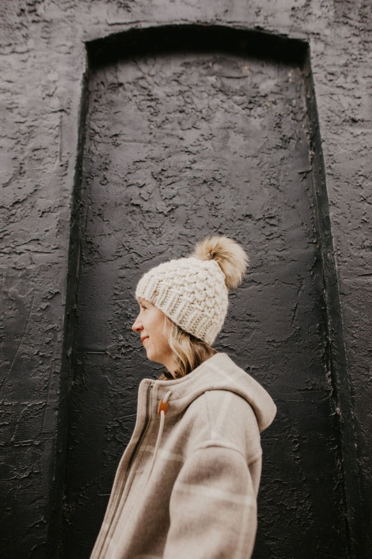 Ivory Peruvian Wool Knit Hat with faux fur pom pom by Woolly Bear Knits, featuring warm Peruvian wool and stylish design.