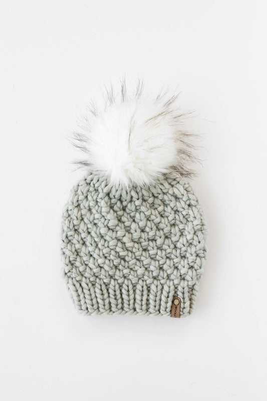 Light gray Peruvian wool knit hat with faux fur pom-pom from Woolly Bear Knits, stylish winter accessory.