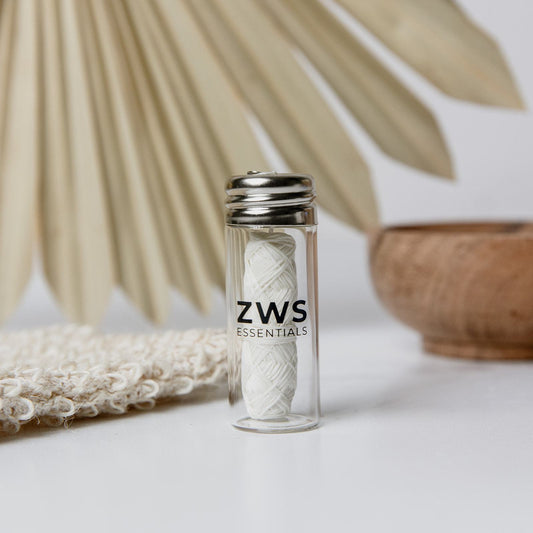 A close-up of ZeroWasteStore.com's Silk Floss—30m of biodegradable, refillable dental floss in a bottle—offers a zero waste, eco-friendly alternative for your oral care routine.