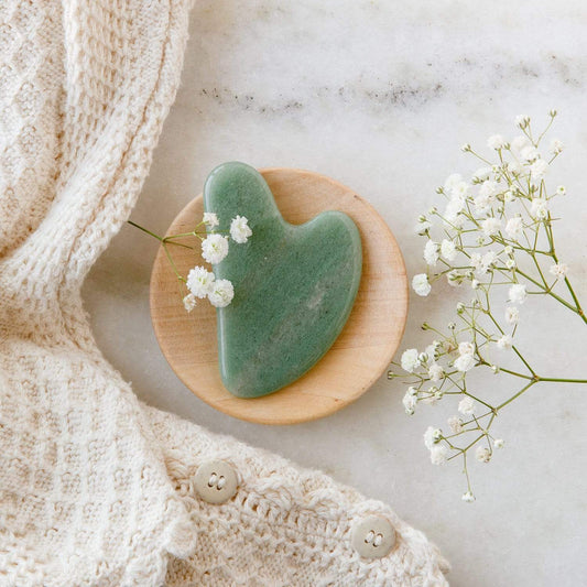 Rose quartz Gua Sha facial tool for skin care, used for facial massage and contouring, from ZeroWasteStore.com.