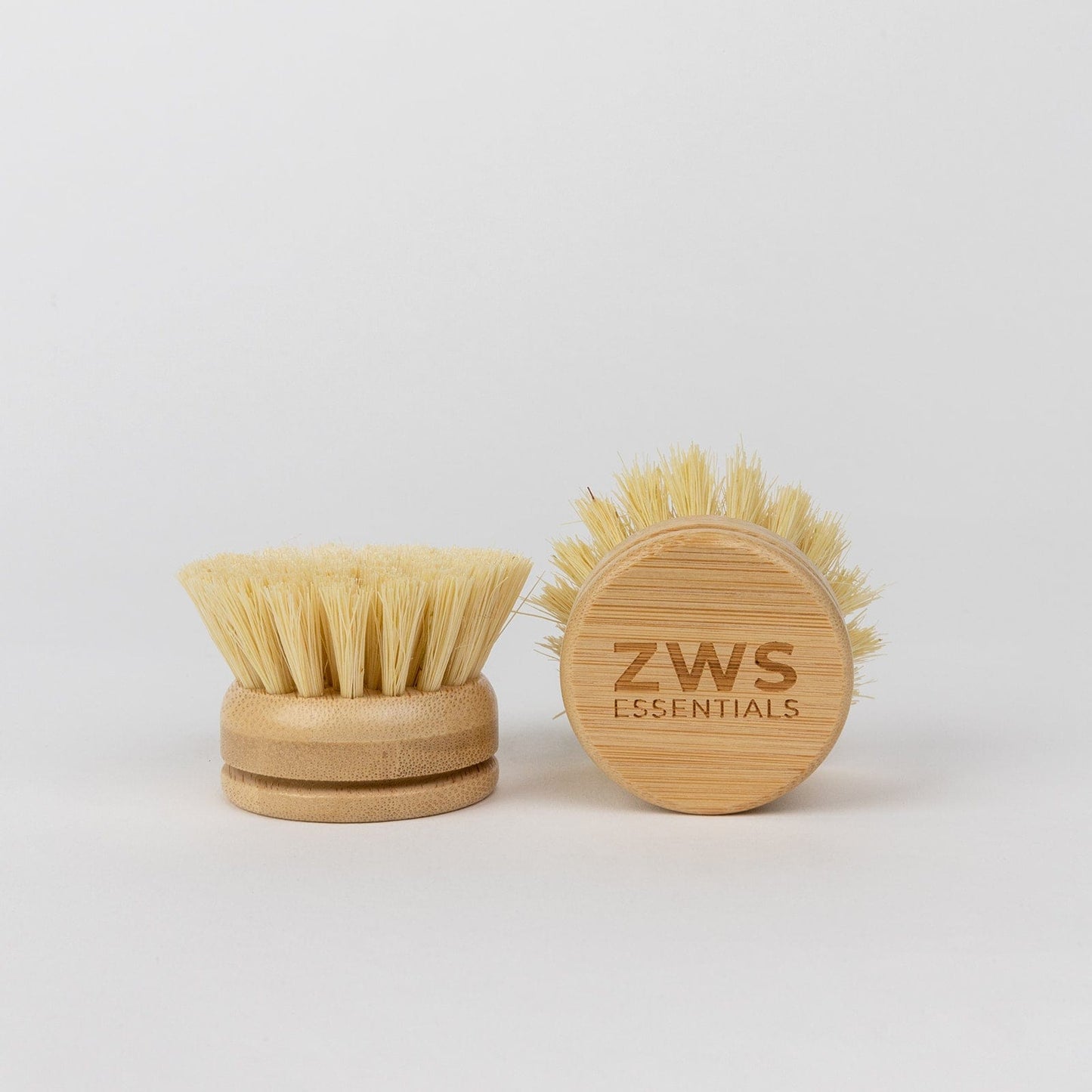 Two Long Handle Dish Brushes from ZeroWasteStore.com are shown. One displays its light bristles, while the other reveals the wooden top engraved with ZeroWasteStore.com, all set against a plain white background.