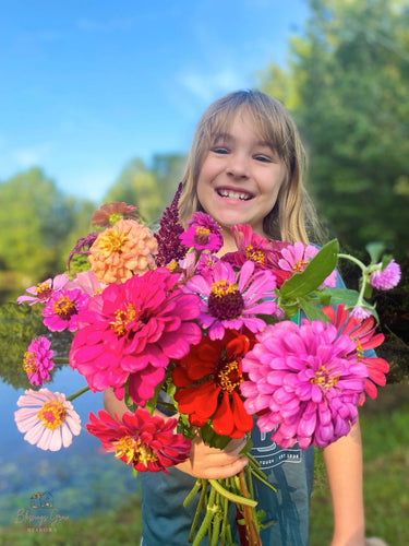 Pretty girl with a bouquet arrangement of fresh flowers in Metter