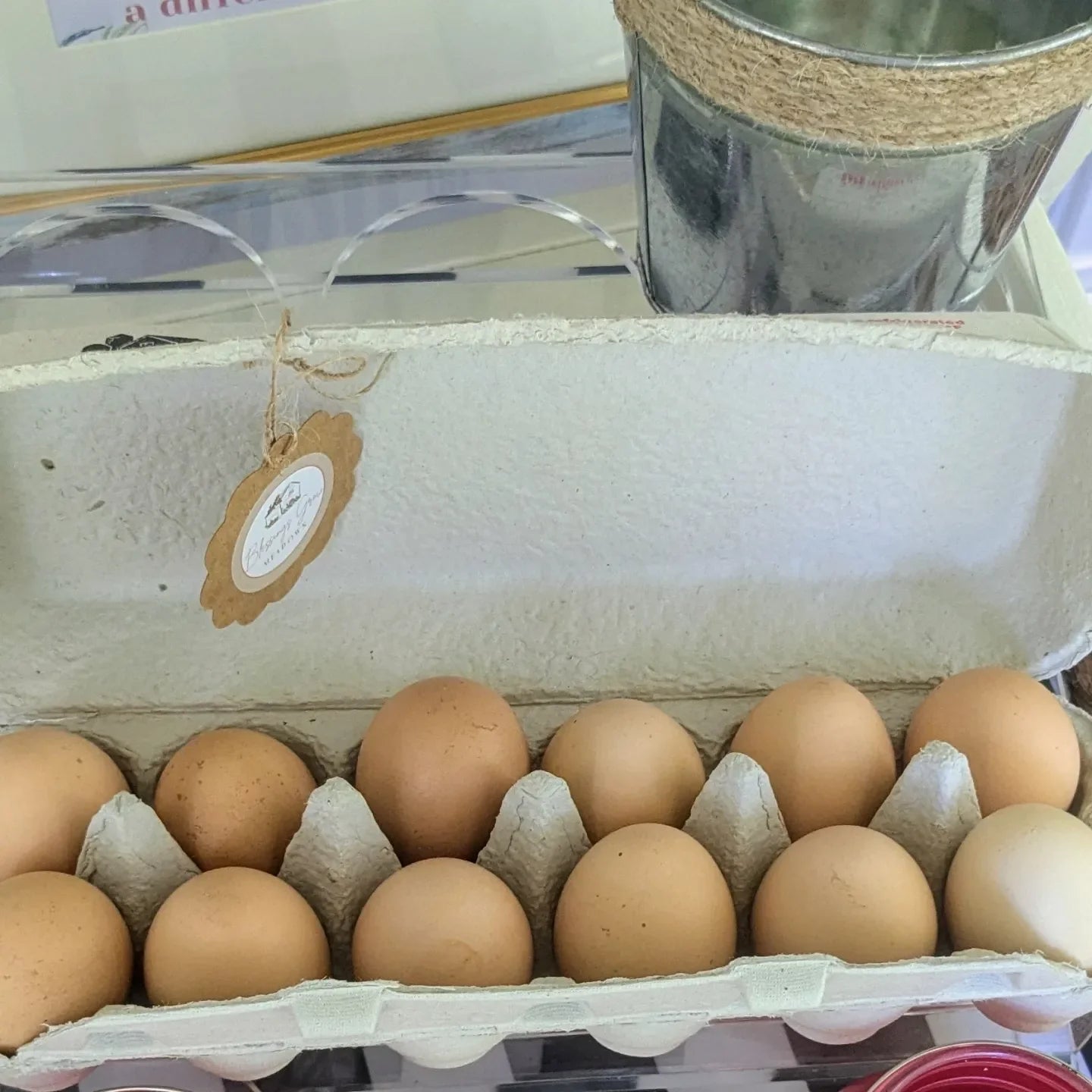 Unwashed farm fresh chicken eggs in a egg container at porch stand