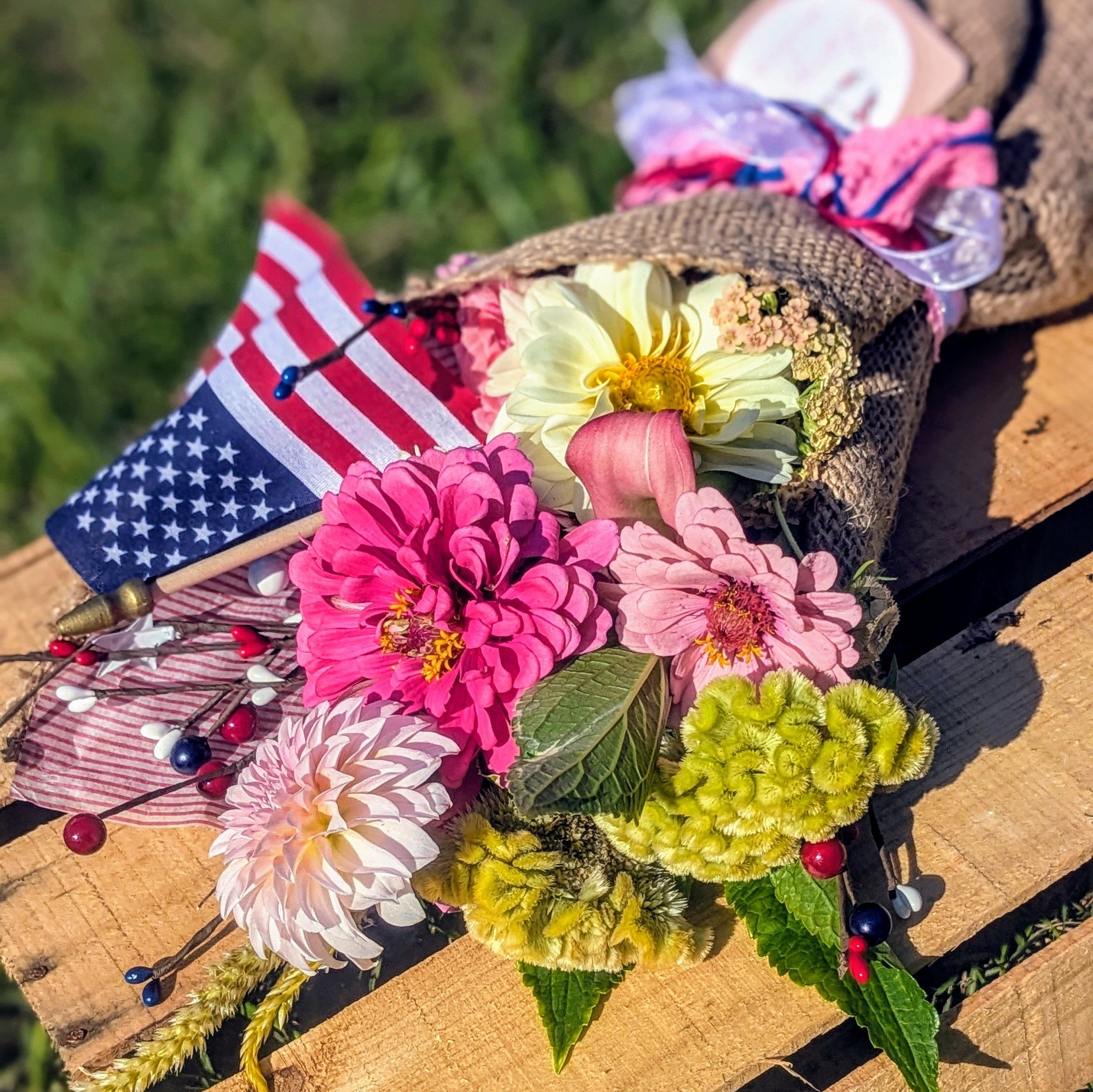 Farm-fresh pink flower arrangement with American flag for the 4th of July