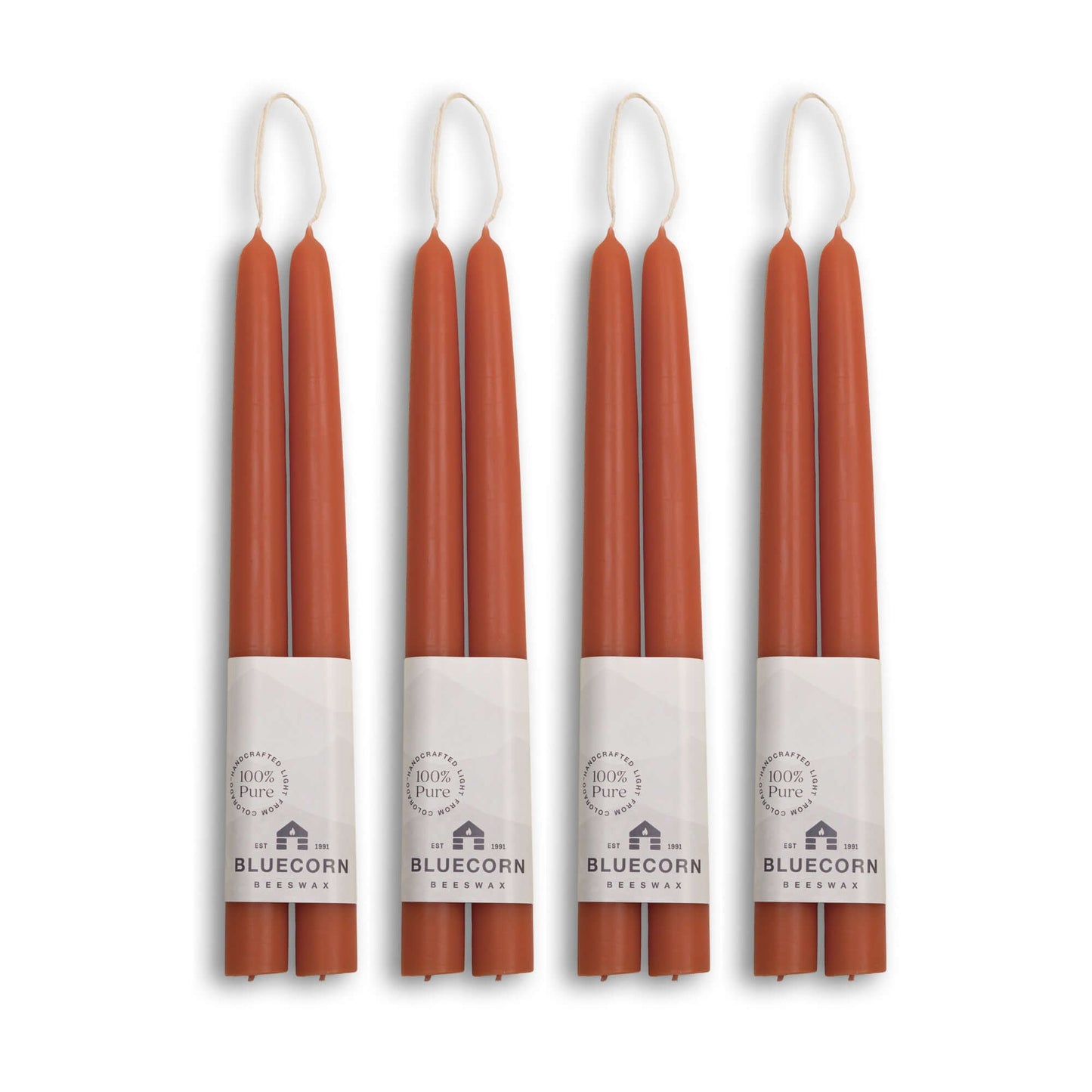 Set of four pairs of 10-inch hand-dipped beeswax taper candles in terracotta color by Bluecorn Candles.