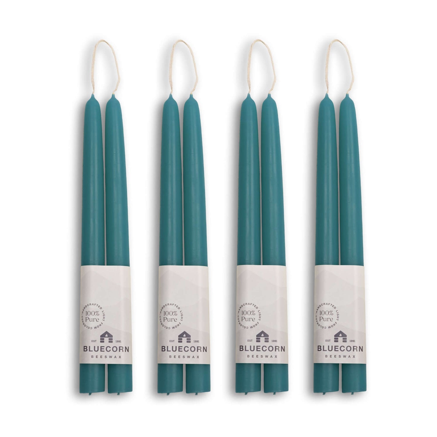 Set of four pairs of 10-inch teal beeswax taper candles from Bluecorn Candles, hand-dipped and natural in appearance.