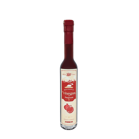 Bottle of Olive Crate 100% organic balsamic vinegar with pomegranate, showing the label and dark balsamic liquid inside.