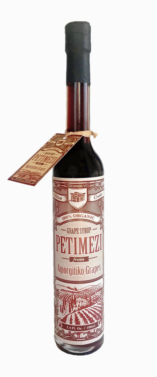 Bottle of Olive Crate 100% organic Petimezi concentrated grape syrup, showing the dark, rich liquid inside a glass bottle.
