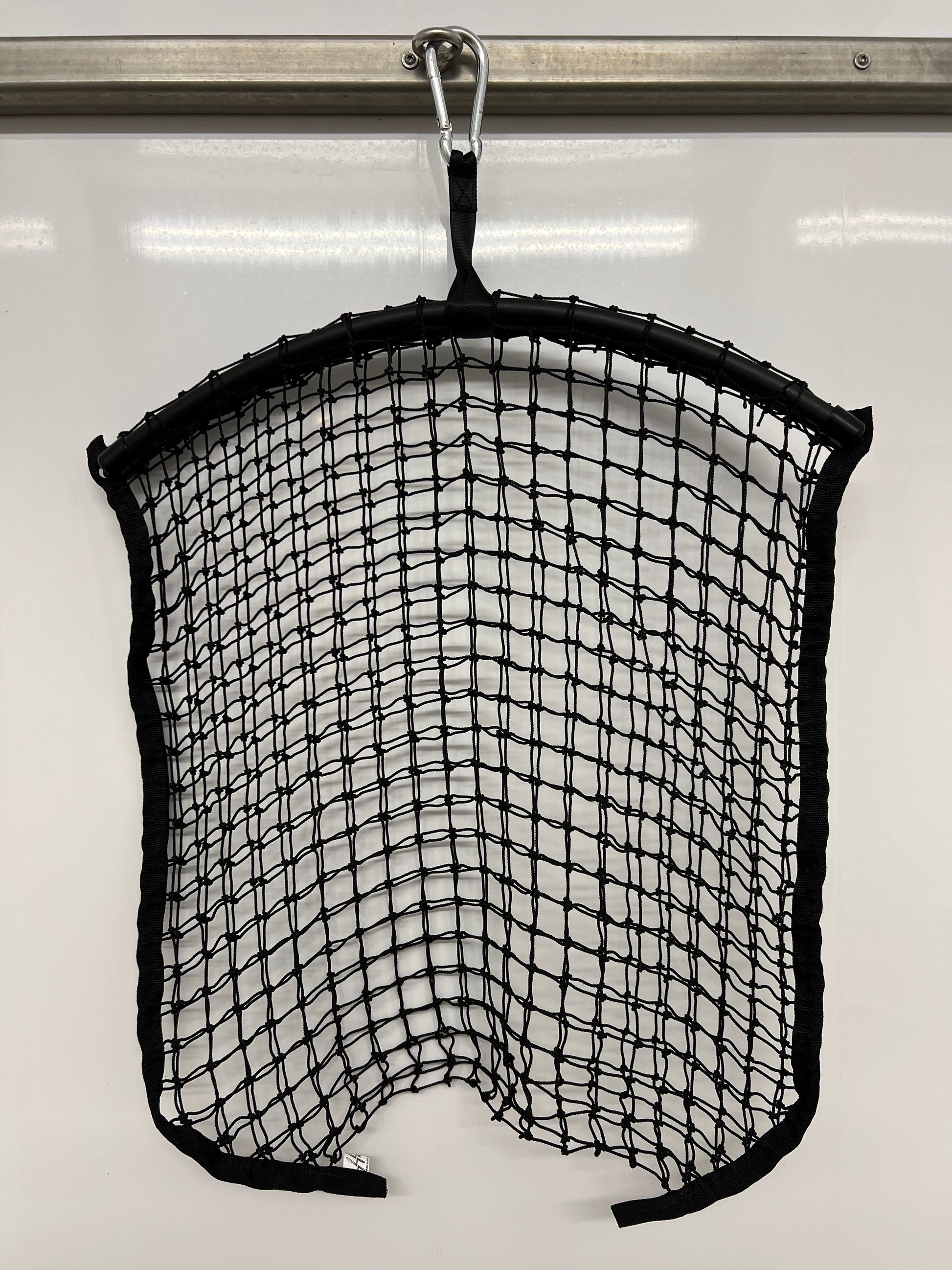 Black regular haynet from Haylo Haynets, LLC, showing a sturdy net for storing or feeding hay in a farm or stable setting.