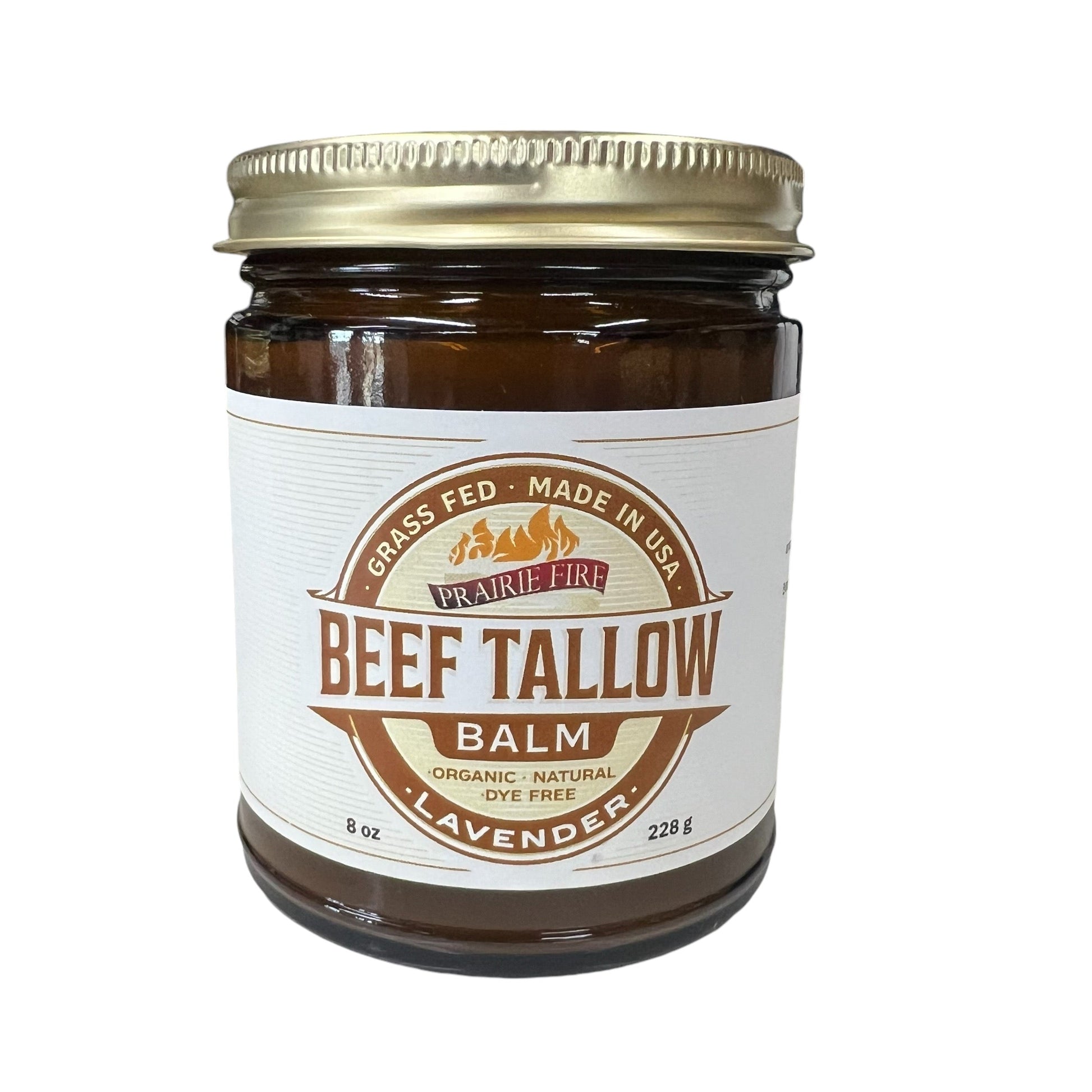 A brown glass jar with a gold lid contains Prairie Fire Tallow’s Beef Tallow Balm (8 oz, lavender scent). Made in the USA from organic grass-fed tallow, this natural moisturizer is dye-free and perfect for skin care.
