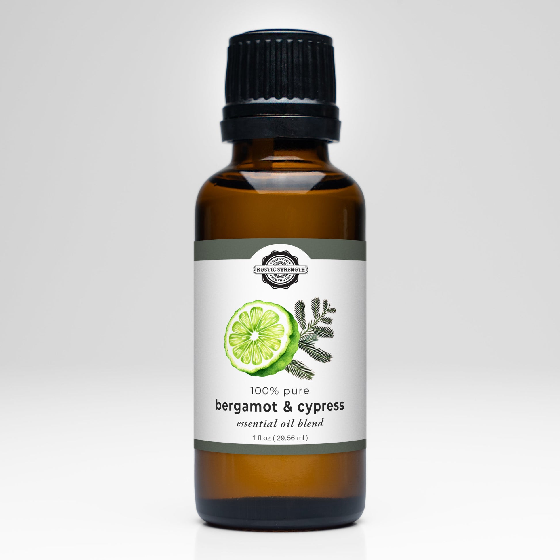 A brown glass bottle with a black cap, labeled Rustic Strength Bergamot & Cypress Essential Oil Blend. Ideal for aromatherapy, the white label shows bergamot slice and cypress sprig illustrations. Contains 100% pure essential oils.