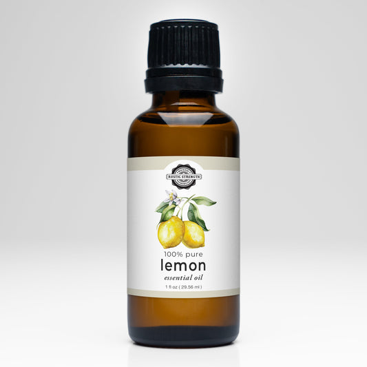 A 1 fl oz (29.56 ml) brown glass bottle of Rustic Strength Lemon Essential Oil with a black cap, labeled 100% pure and featuring lemons and leaves—perfect for aromatherapy or your essential oil collection.