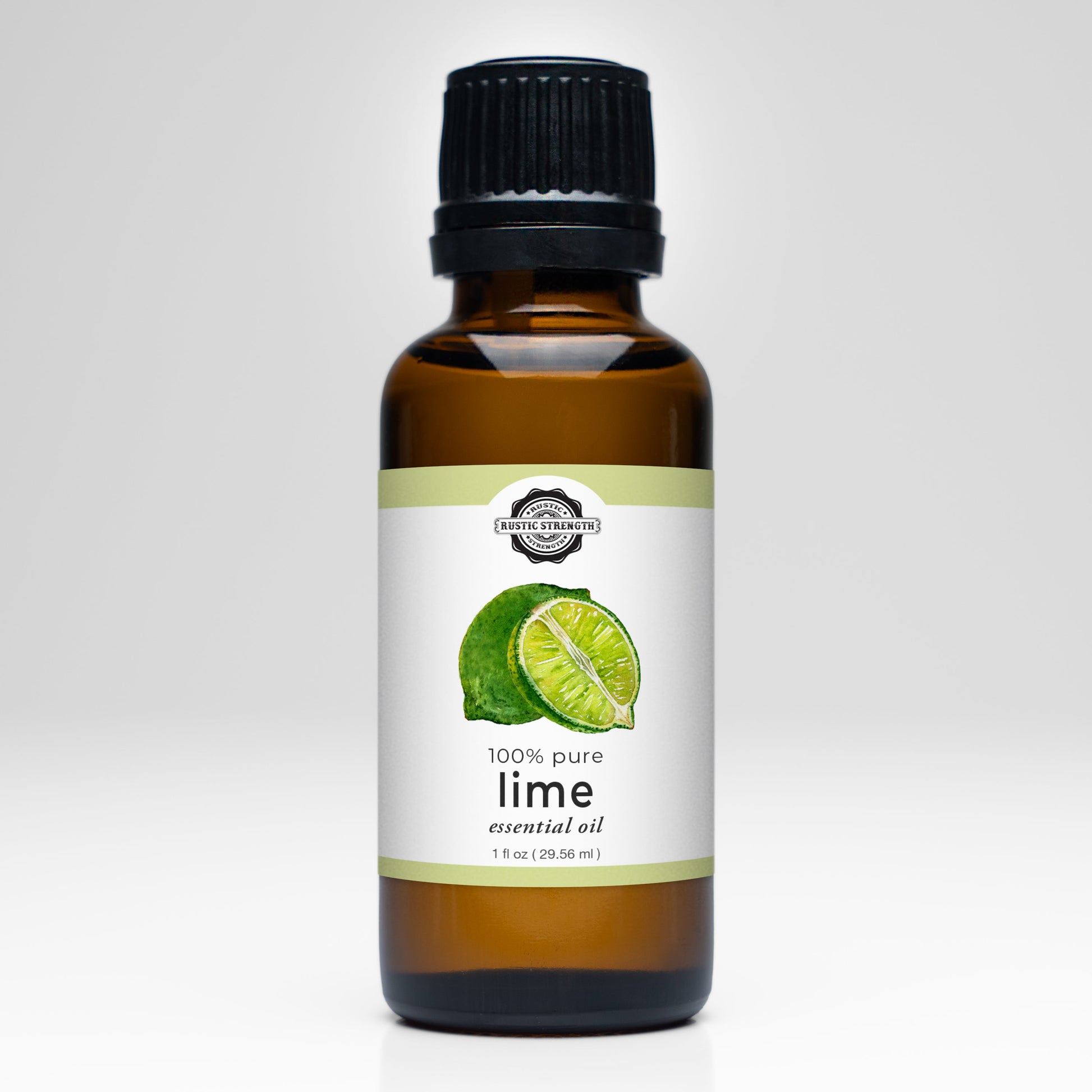 Rustic Strength Lime Essential Oil comes in a 1 fl oz (29.56 ml) brown glass bottle with a black cap, labeled 100% pure Citrus Aurantifolia. The label features a whole lime and slice, perfect for aromatherapy use.