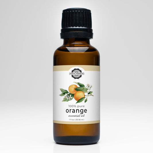 A 1 fl oz (29.55 ml) brown glass bottle of Rustic Strength Orange Essential Oil with a black cap, labeled 100% pure and featuring oranges and leaves—ideal for aromatherapy and essential oil uses.