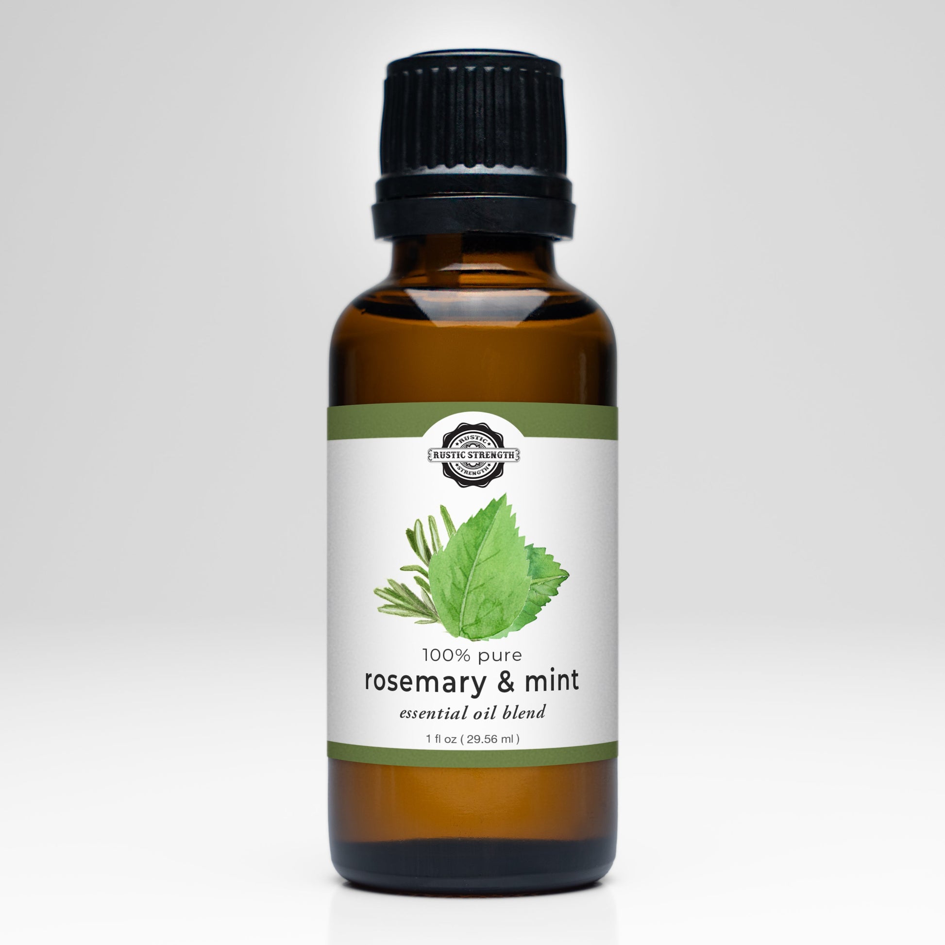 A brown glass bottle with a black cap labeled Rustic Strength Rosemary & Mint Essential Oil Blend, featuring rosemary and mint leaf illustrations. Ideal for aromatherapy or adding fresh scents to laundry.