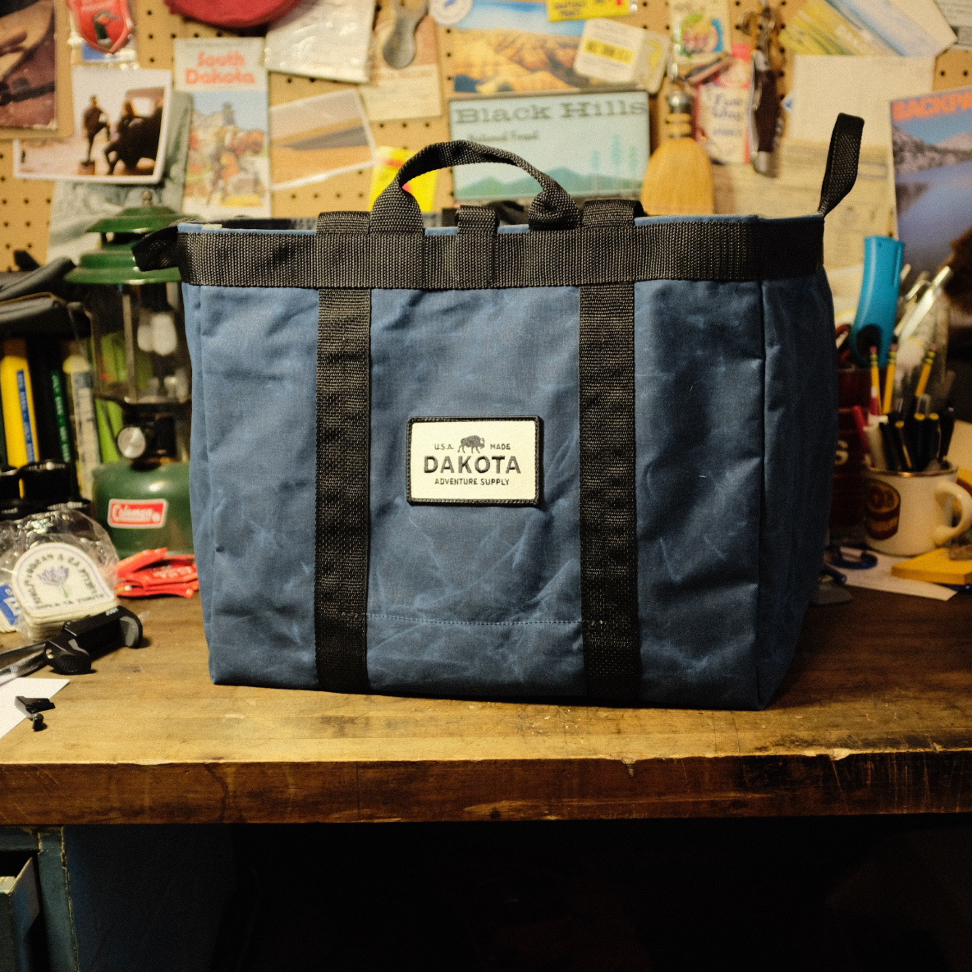 Waxed canvas adventure tote bag by Dakota Adventure Supply with leather handles and spacious interior for outdoor gear storage.