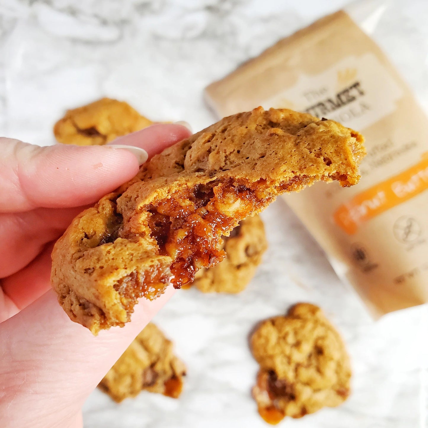 Peanut butter granola in a pack of two 12 oz bags from The Gourmet Granola, gluten, soy, and dairy free, displayed in a natural setting.