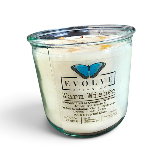 Rocks Candle Warm Wishes soy candle with wood wick, featuring citrine and aventurine gemstones, in a decorative glass jar.