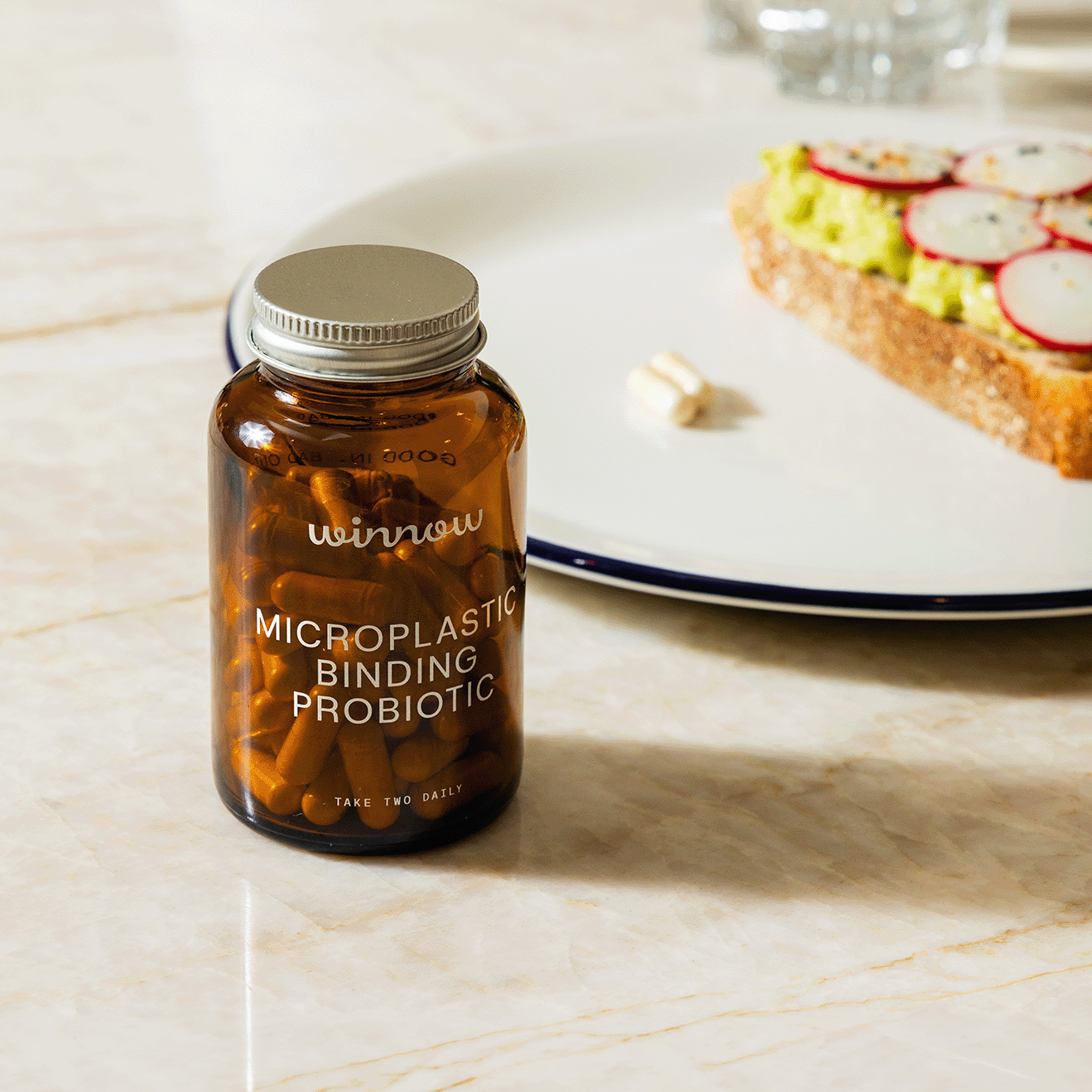 Winnow Daily Probiotic Starter Pack with supplement bottles and packaging, featuring colorful labels and health benefits.