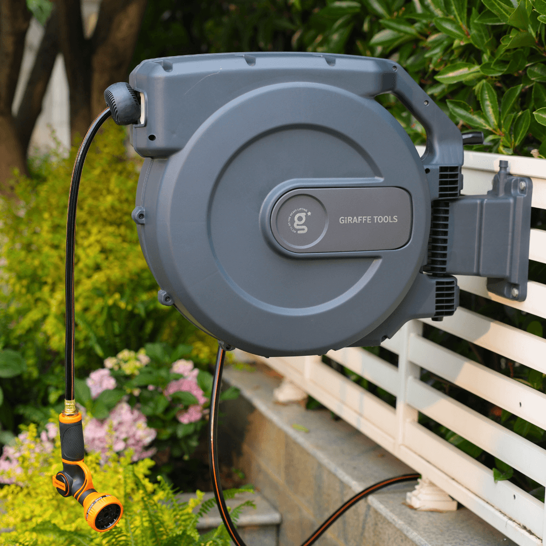 Giraffe Tools US retractable garden hose reel with 5/8 inch, 115 ft hose, mounted on wall for easy watering and storage.