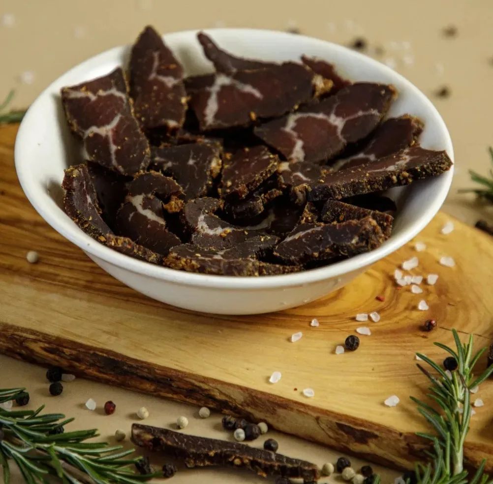 Sliced Smokehouse Beef Biltong bundle by Farmer Bill's Provisions, featuring thinly sliced, flavorful beef biltong in a 1/2 lb package.
