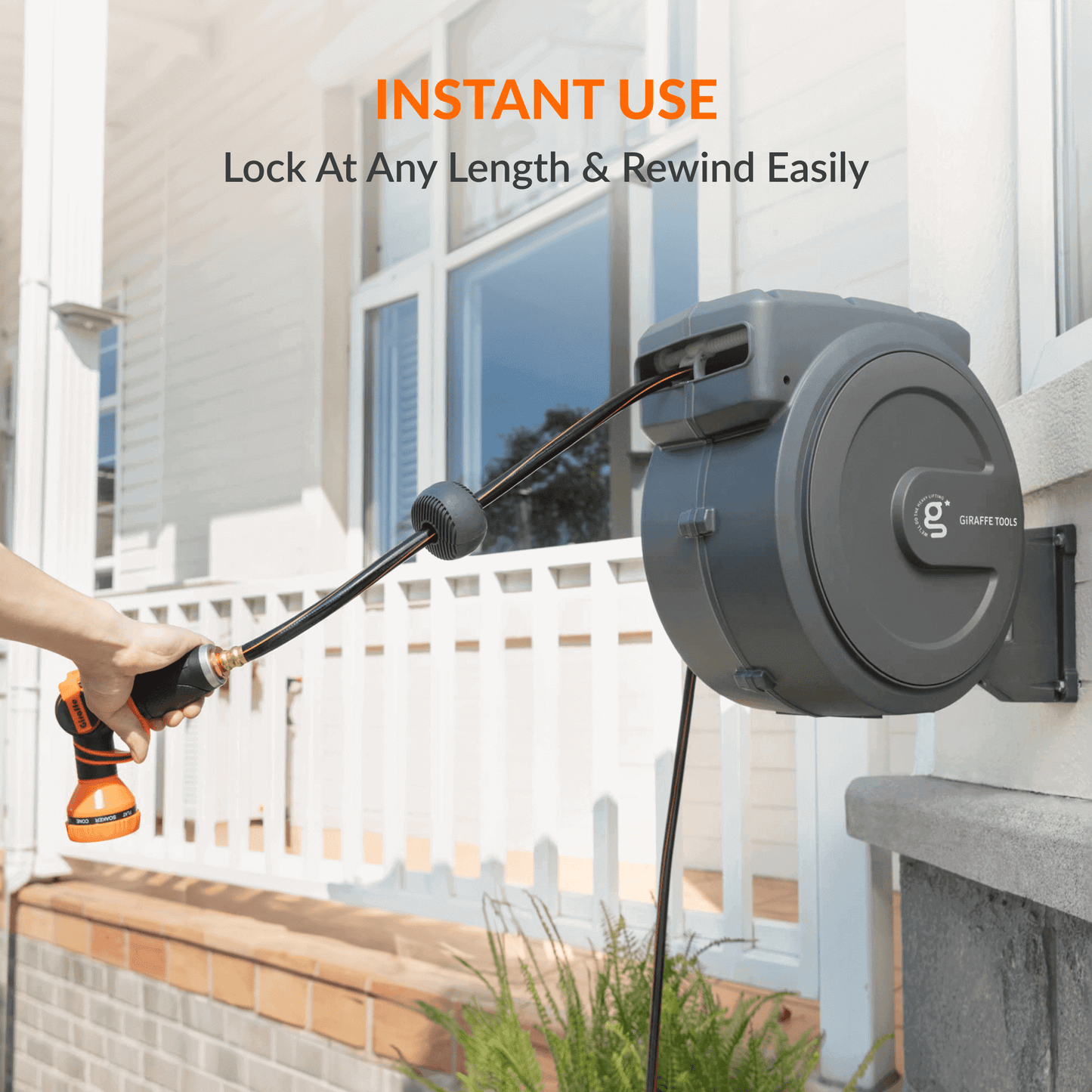 Giraffe Tools US retractable garden hose reel with 5/8 inch, 115 ft hose, mounted for easy watering and storage in the garden.