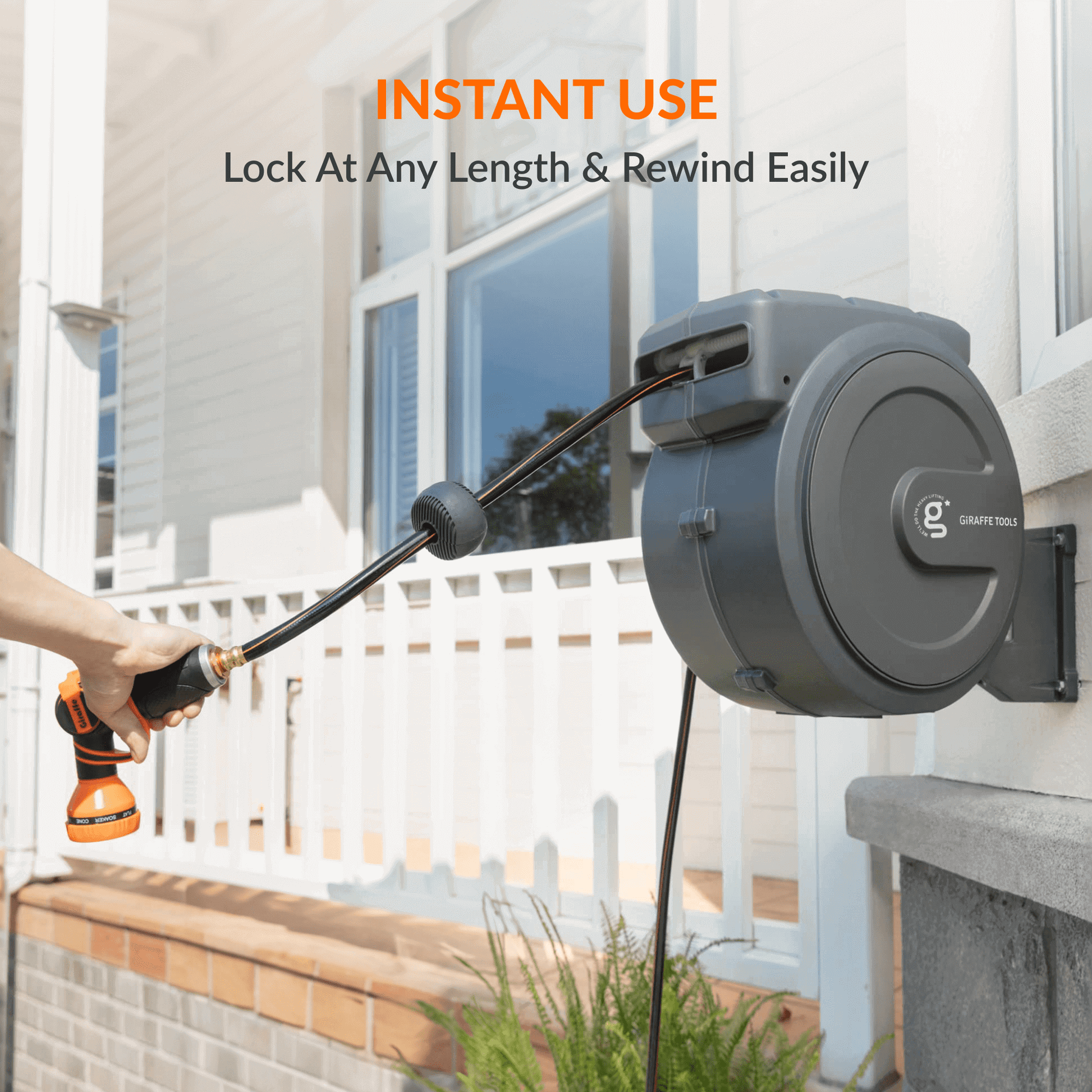 Giraffe Tools US retractable garden hose reel with 5/8 inch, 115 ft hose, mounted for easy watering and storage in the garden.