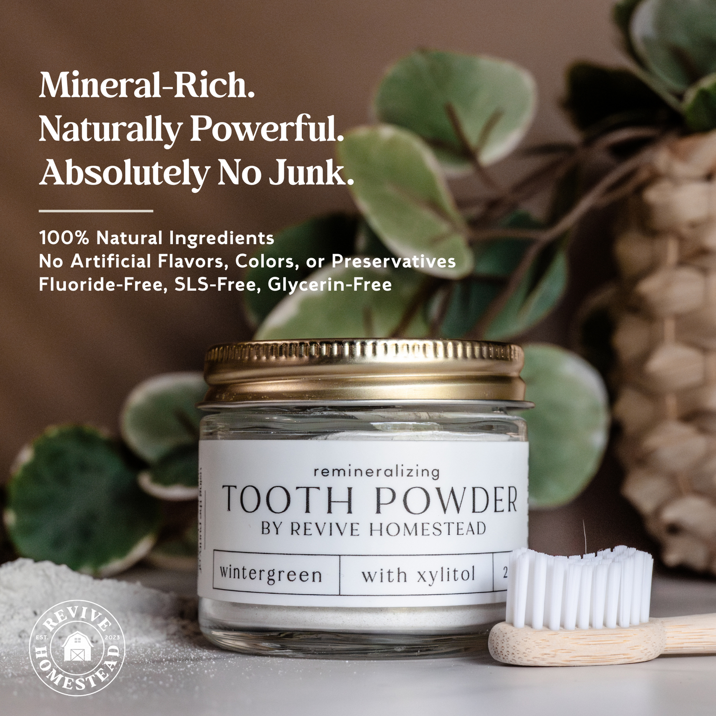 Revive Homestead remineralizing tooth powder with hydroxyapatite, sweetener-free, in a clear jar showing the powder inside.
