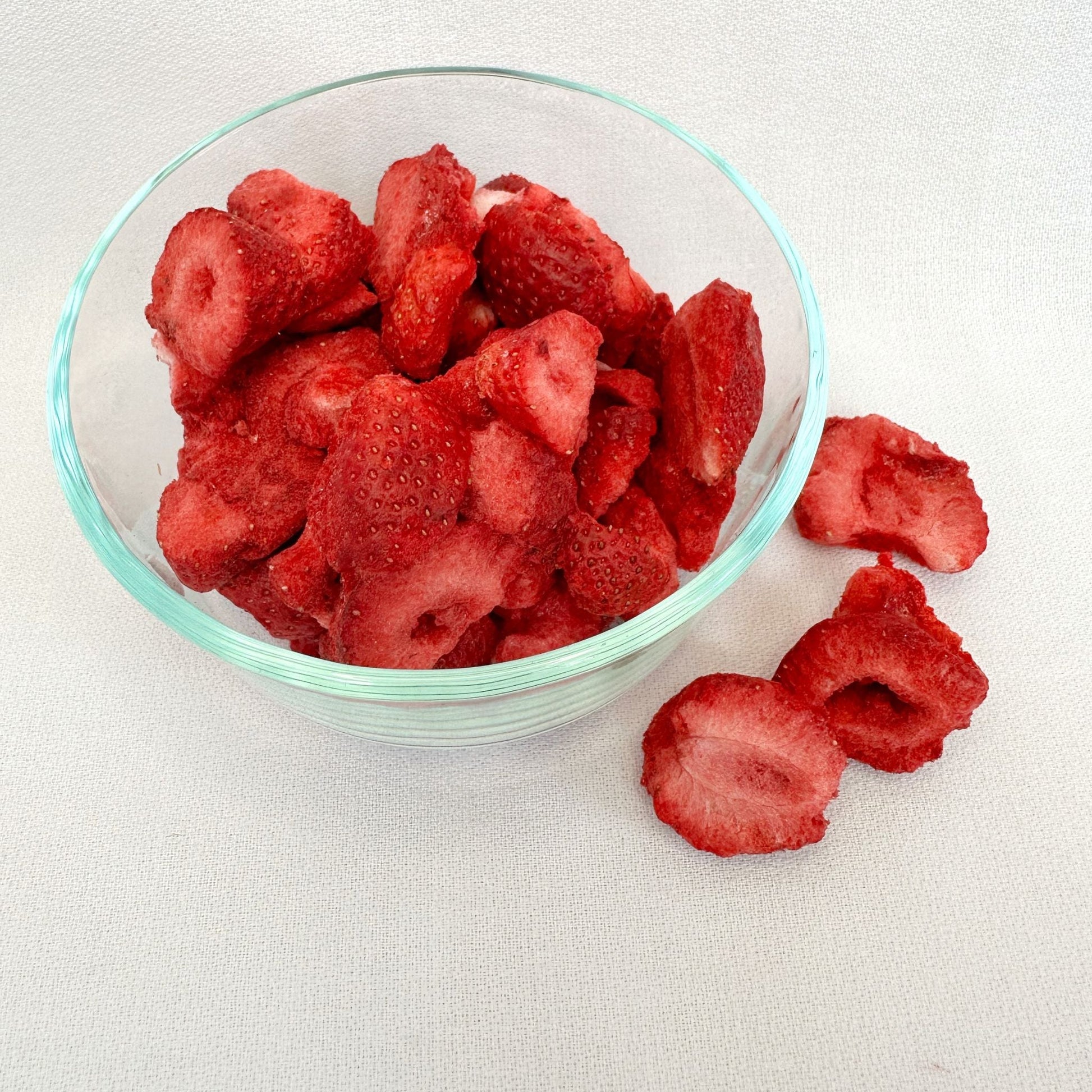 Freeze dried strawberries from Double L Ranch, showing vibrant red, crunchy texture, and small berry pieces in the image.