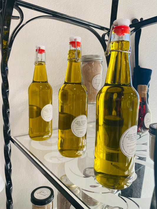 Bottle of Onic Brands Italian Reserve Extra Virgin Olive Oil with a dark glass container and label, on a kitchen countertop.
