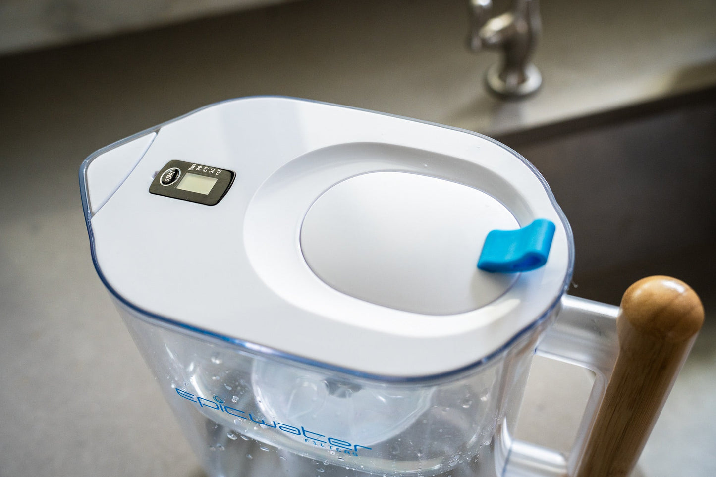 Epic Water Filters Pure XP pitcher with red handle and lid, designed to reduce fluoride, PFAS, and parasites from tap water.
