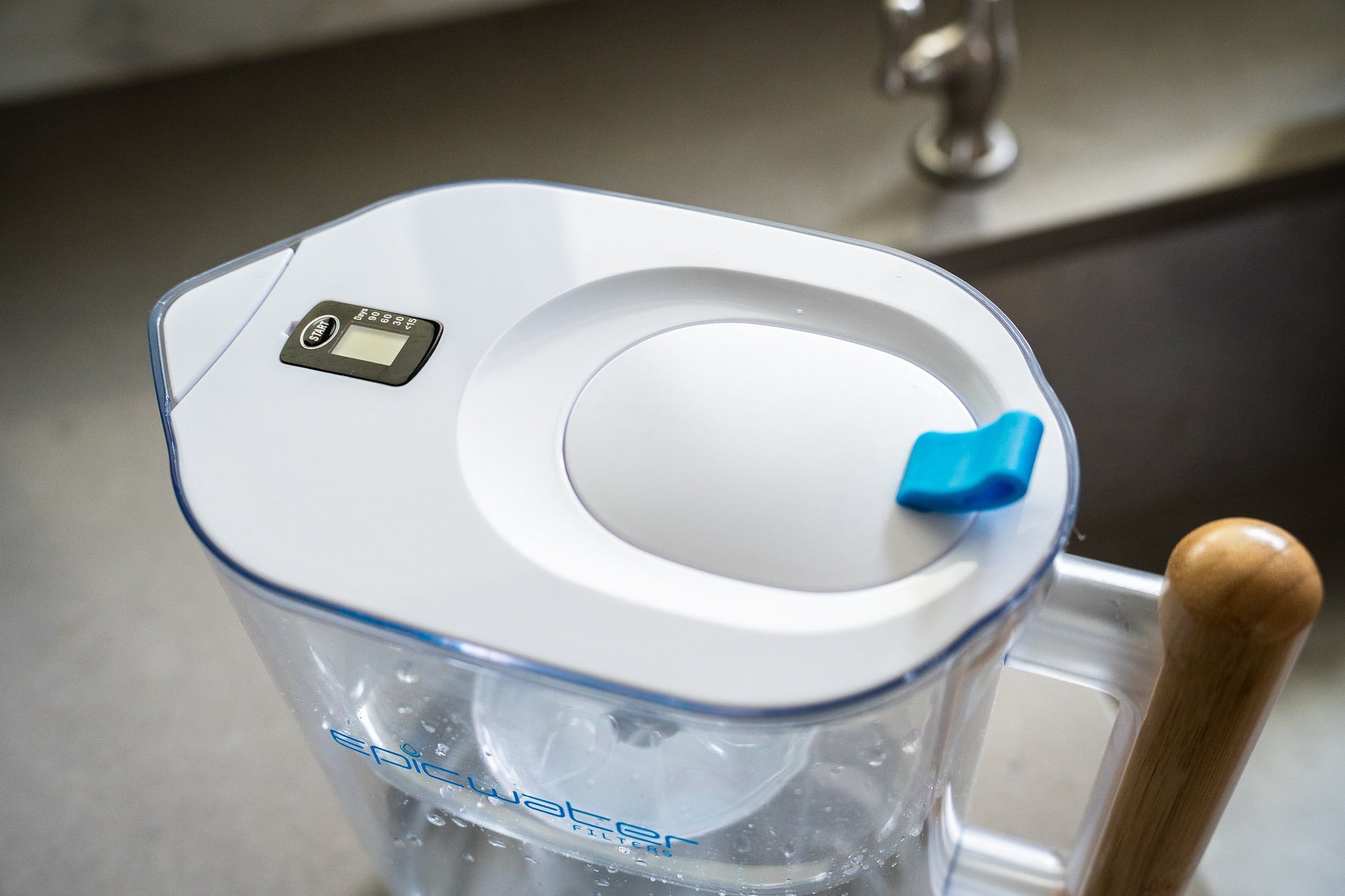 Epic Water Filters Pure XP pitcher with red handle and lid, designed to reduce fluoride, PFAS, and parasites from tap water.