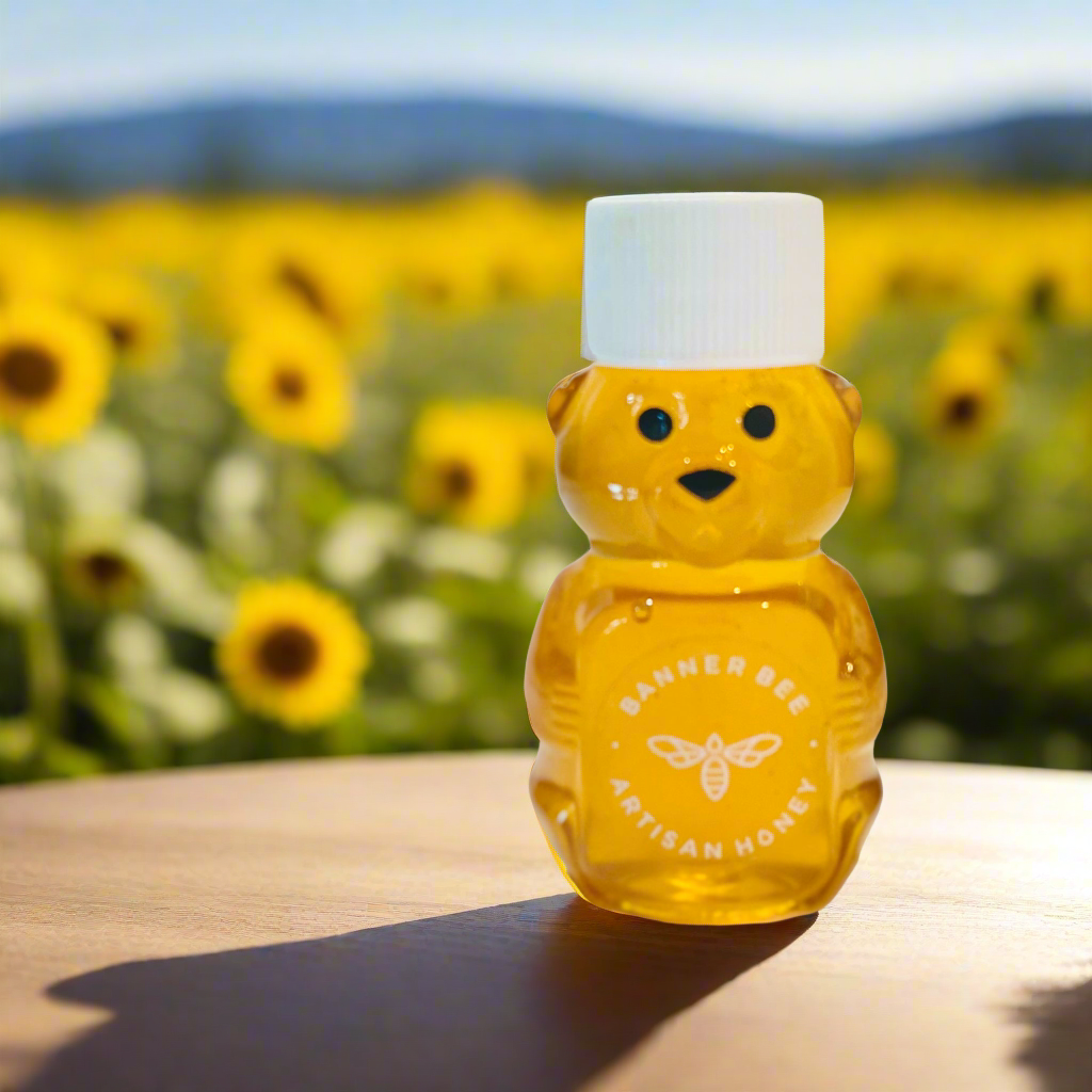 Mini honey bear jar filled with raw honey from BannerBee Company LLC, showcasing the adorable honey container.