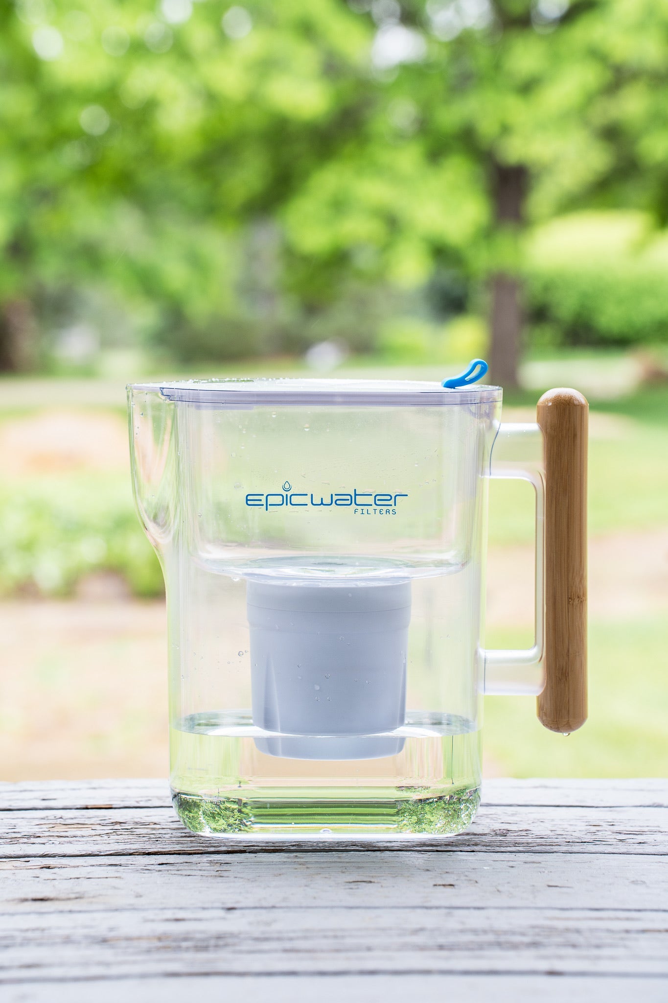 Epic Water Filters Pure XP pitcher with red handle and filter, designed to reduce fluoride, PFAS, and parasites from drinking water.