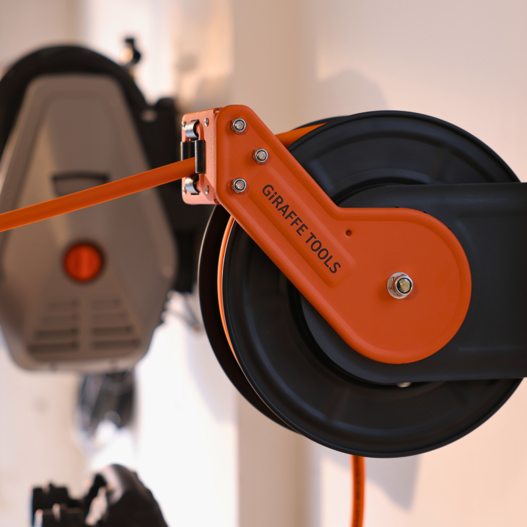 Giraffe Tools US retractable air hose reel with alloy steel body, 3/8 inch diameter, 15 meters long, mounted for easy hose storage.