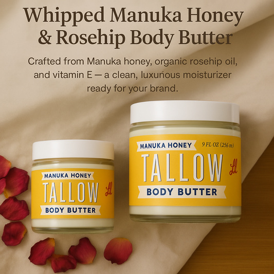 Two jars of Lady May Tallow’s Manuka Honey & Rosehip Tallow Body Butter, one small and one large, sit on cream fabric with rose petals. Their label features nourishing manuka honey and rosehip oil for deep, luxurious hydration.