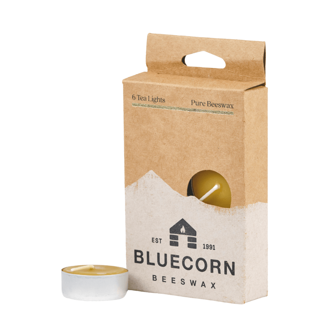 Set of four Bluecorn Candles pure beeswax tea light candles with unlit wicks, displaying natural beeswax texture and warm color.