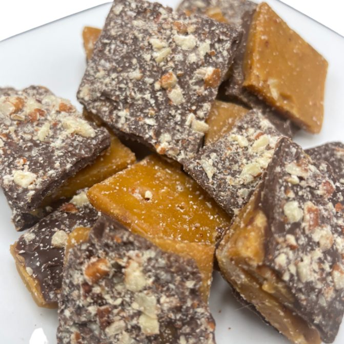 Homemade milk chocolate toffee with mixed nuts, bar-style, from Barb's Buttery Toffee, 8 oz, displayed on a plate.