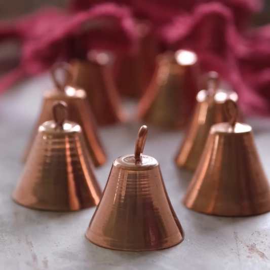 Sertodo Copper Mantra Bell with intricate engraved design, shiny copper finish, and traditional bell shape.