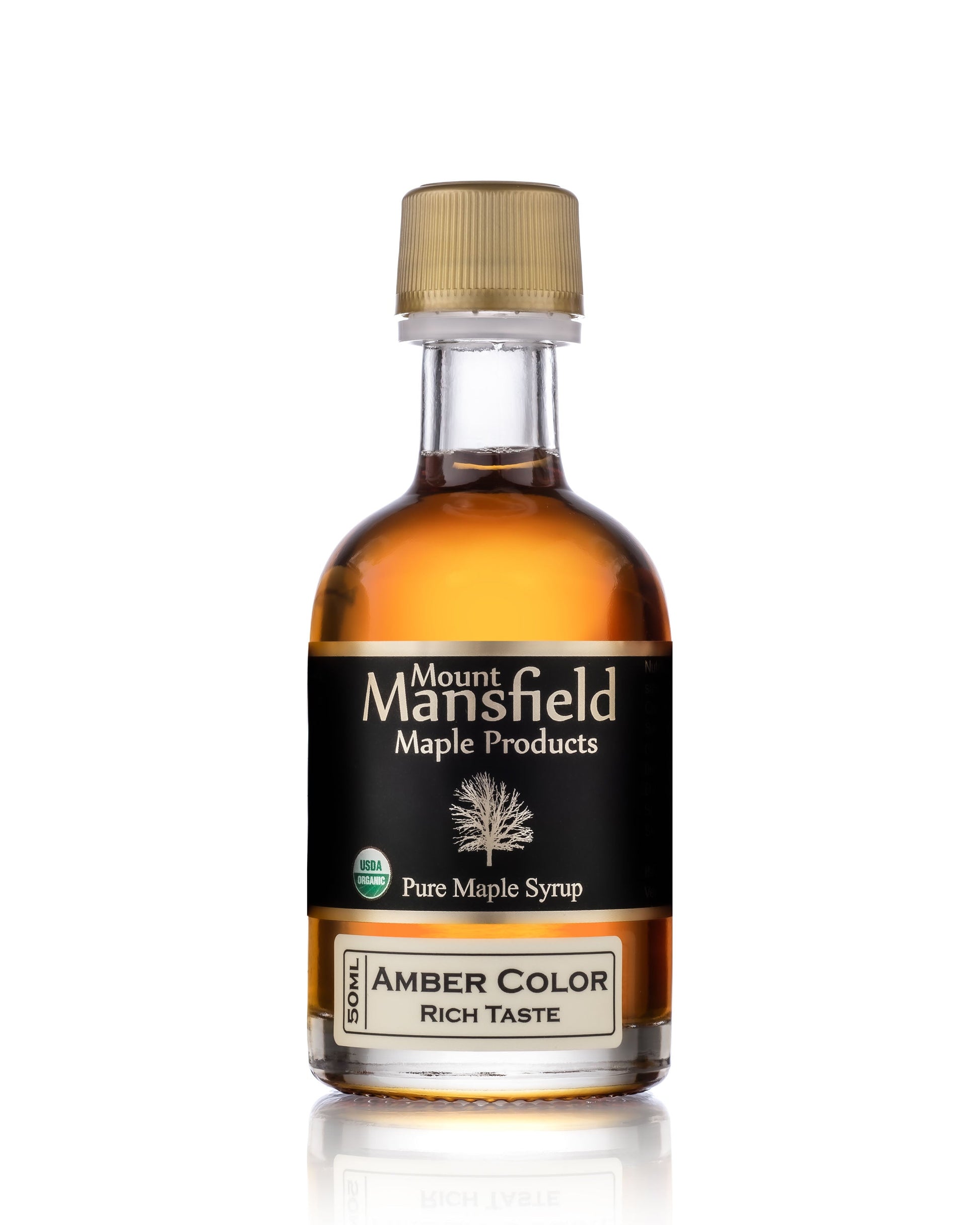 Glass jug of Mount Mansfield Maple Products organic pure Vermont maple syrup in amber color, 50ml size.