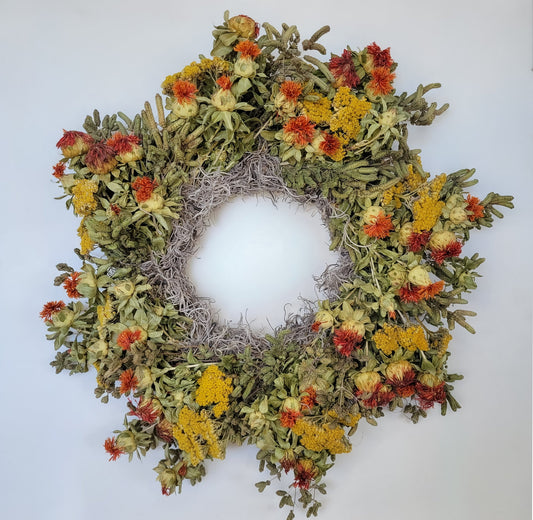Handmade dried flower wreath in vibrant orange with natural floral accents from Sunny Meadows Flower Farm.