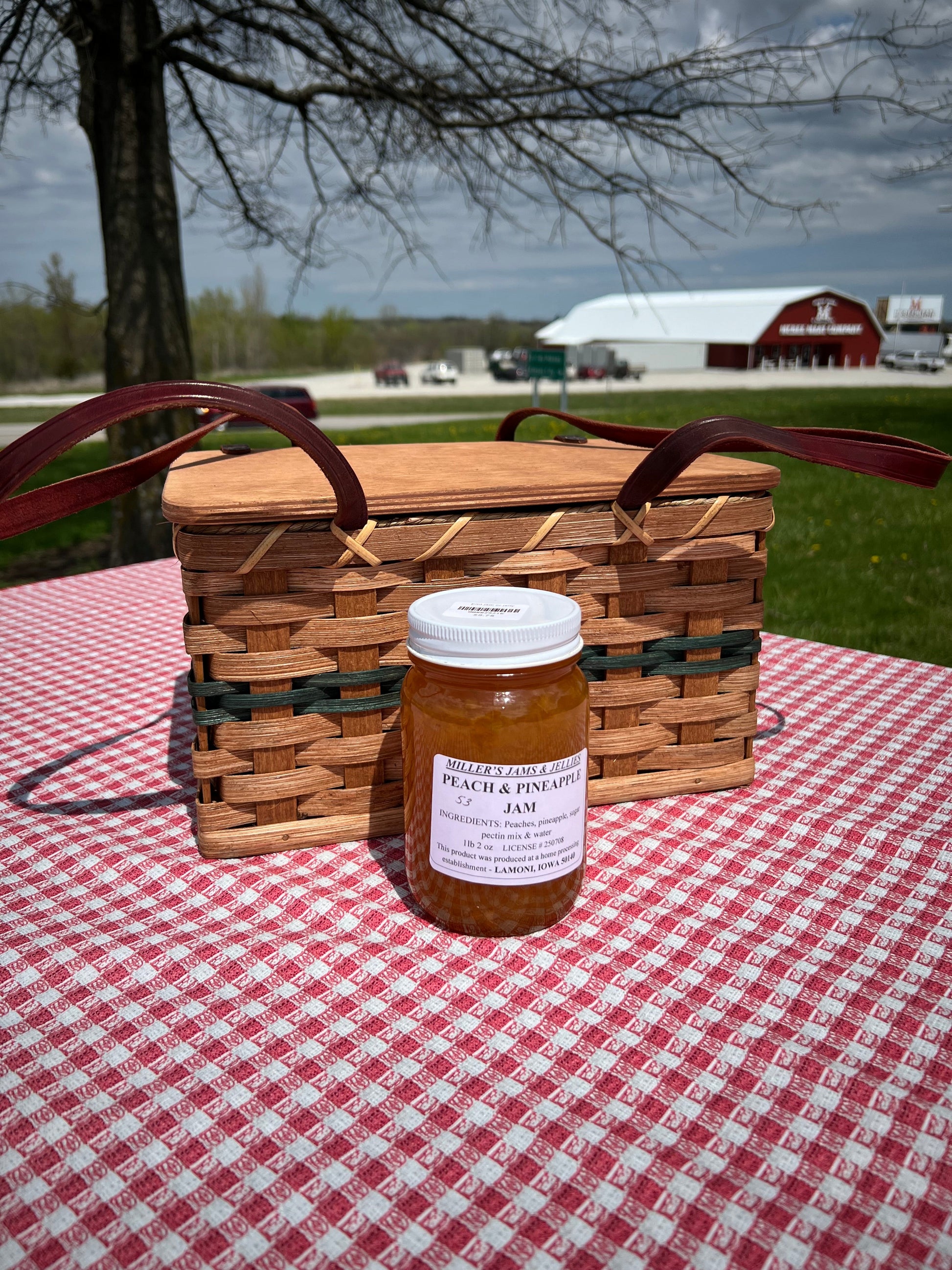 Jar of Amish Miller’s Peach and Pineapple Jam from Amish Country Store, showcasing the fruit-filled preserve with a colorful label.