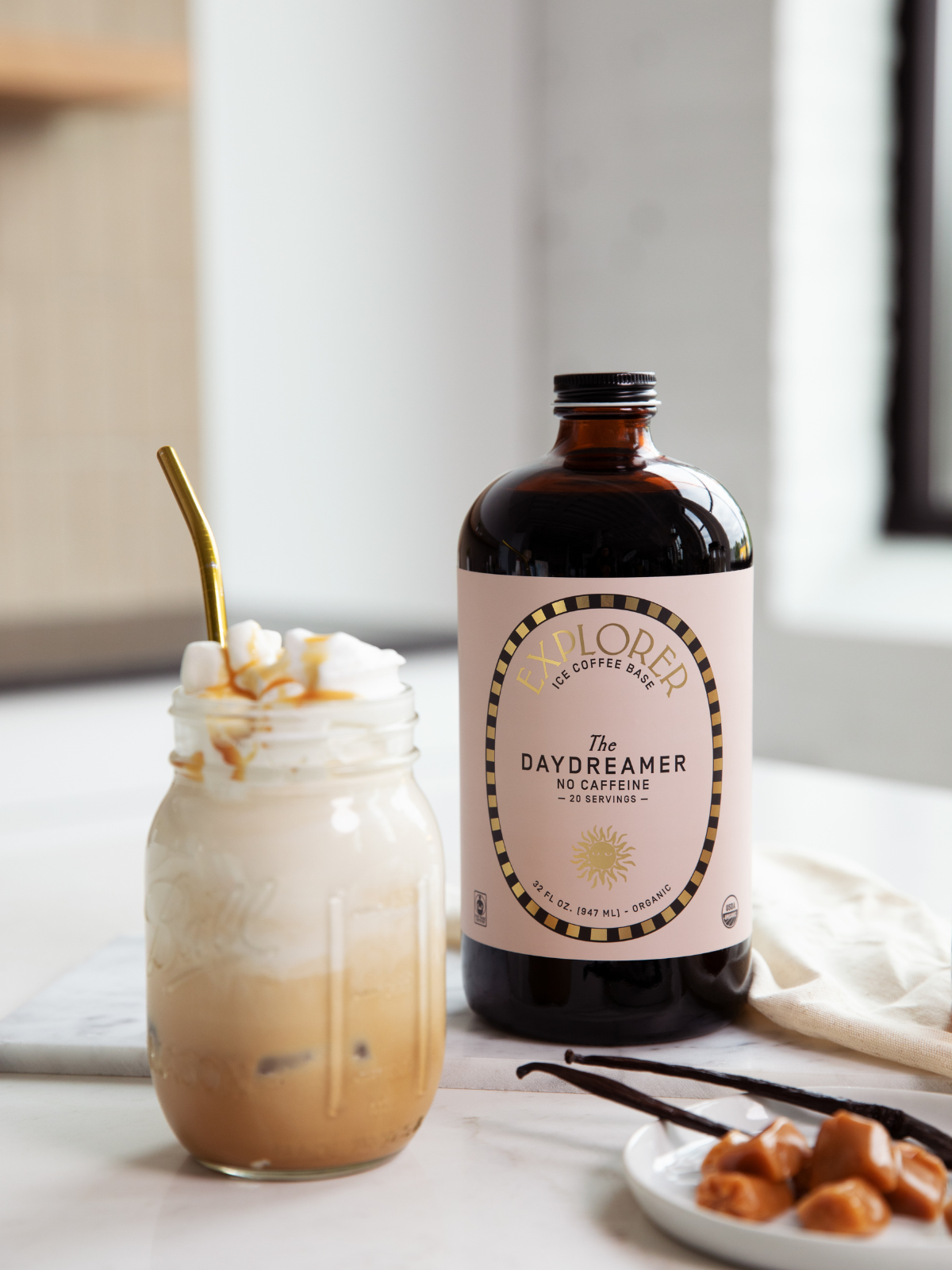 Bottle of Explorer Cold Brew 32oz cold brew coffee concentrate with black label and clear cap on a white background.