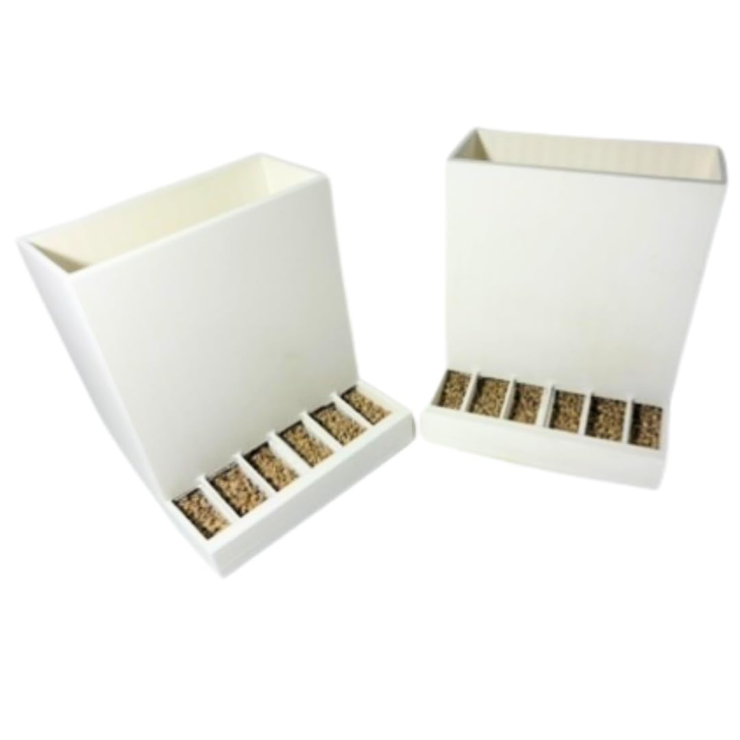 Pair of Quailz.com front-slot quail feeders with adjustable spill-resistant design for hatching time in Chimuka cage systems.