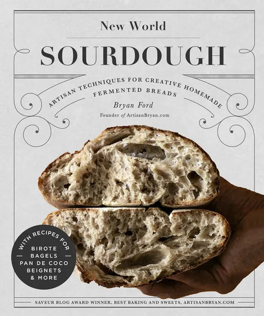 Open hardcover book titled "New World Sourdough" showcasing artisan bread recipes including Birote, Bagels, and Pan de Coco.