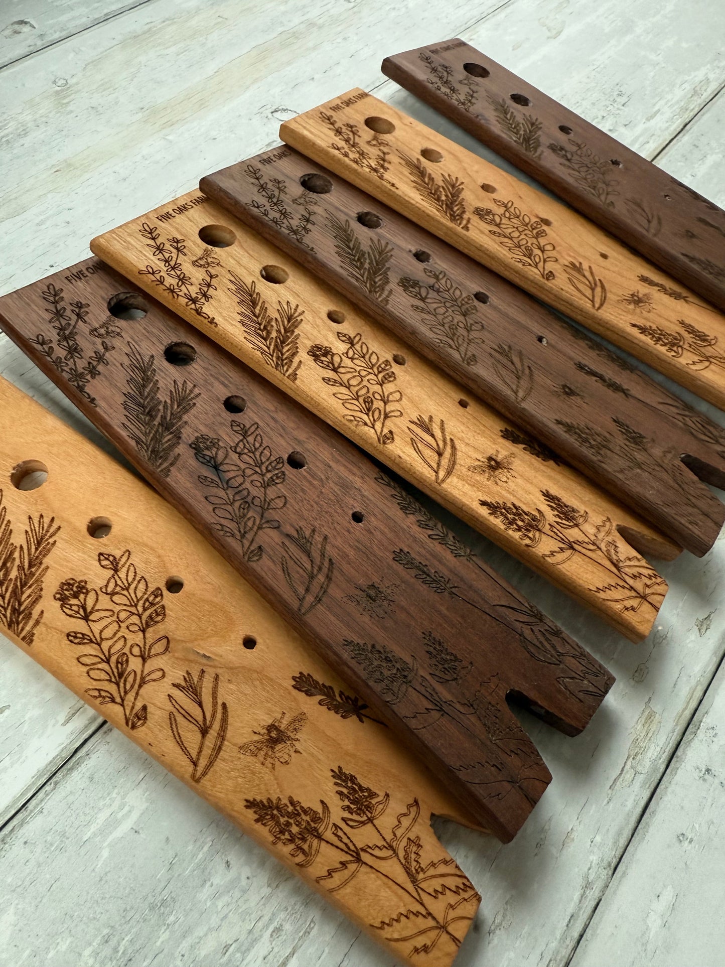 Herb stripper by Five Oaks Farm with metal prongs and wooden handle for easy herb removal and harvesting.